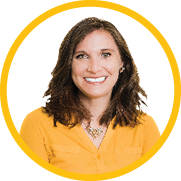A woman with long brown hair, wearing a yellow blouse and a necklace, smiles at the camera. She is framed by a yellow circular border on a white background.